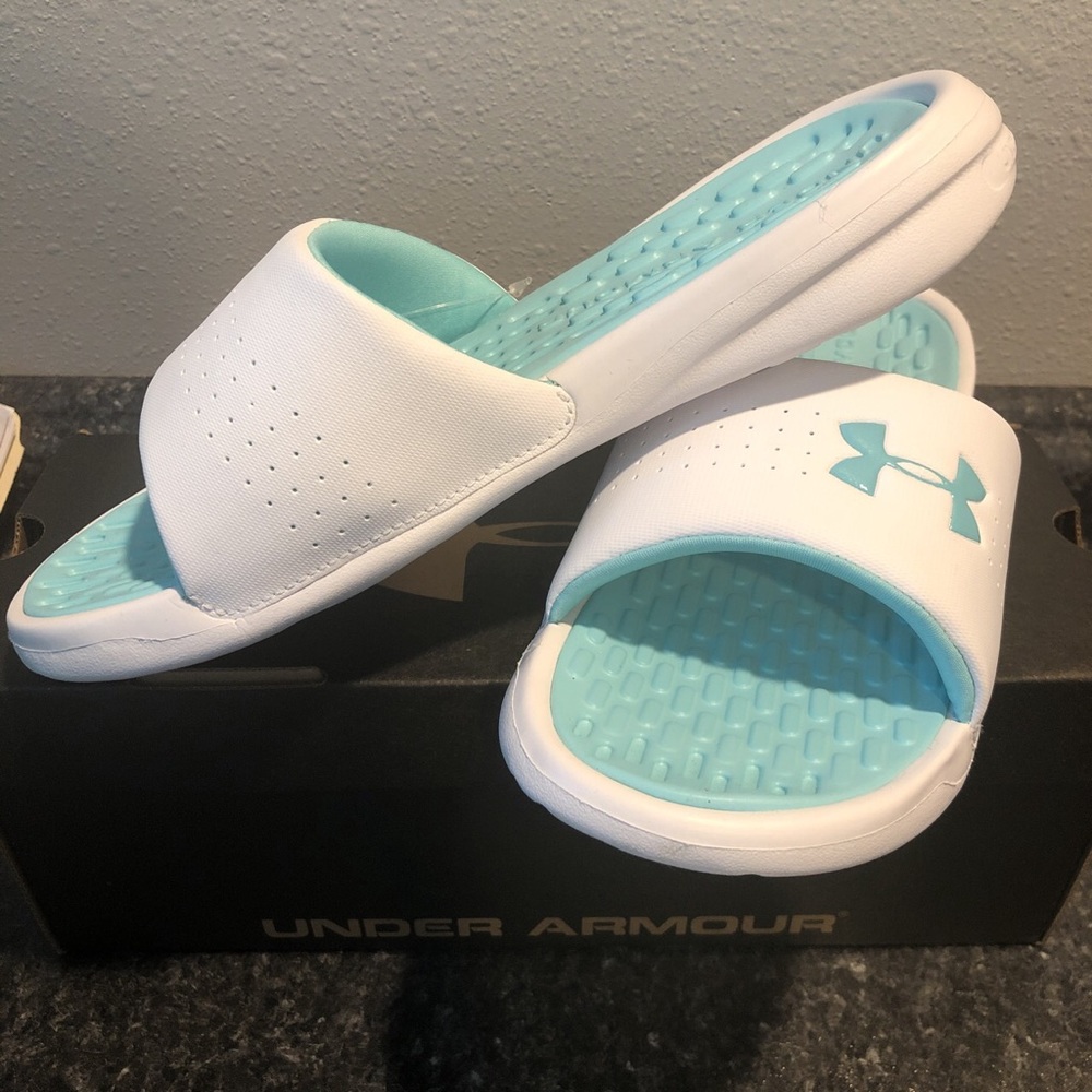 White and teal women’s under armour slides